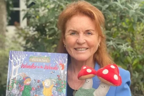 Sarah Ferguson takes a photo with her children's book 'Flora and Fern: Wonder in the Woods'.